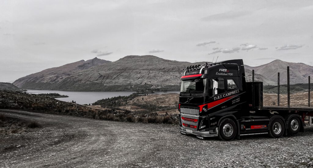D & J Campbell Volvo FH16 780 timber lorry above a Highland loch